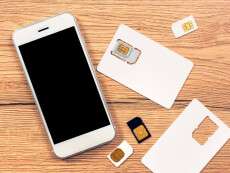 smartphone-with-blank-screen-and-sim-cards-on-the-table-top-view